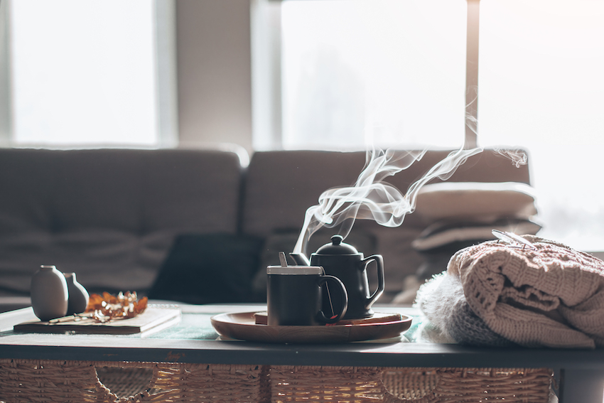 Combating seasonal depression: Cosy home set-up with hot tea and blankets