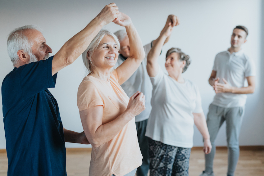exercises reduce stress - Seniors dancing together in a dance class
