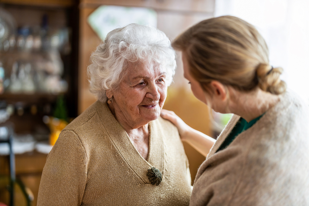 Carer supporting a lady with dementia