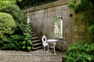 Simple landscaping: Mirror and vintage chair in courtyard garden